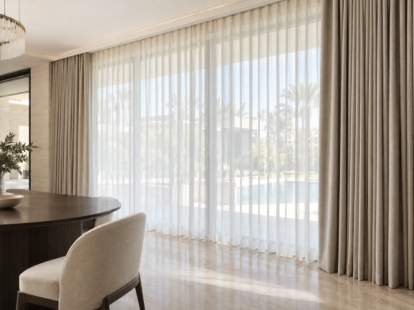 Layered sheer and blackout curtains along a floor-to-ceiling villa window