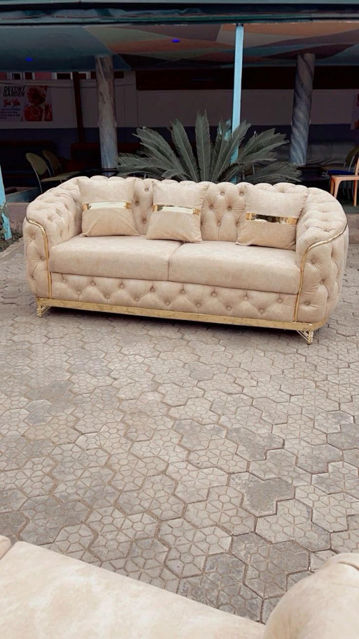 Chesterfield sofa with gold trim